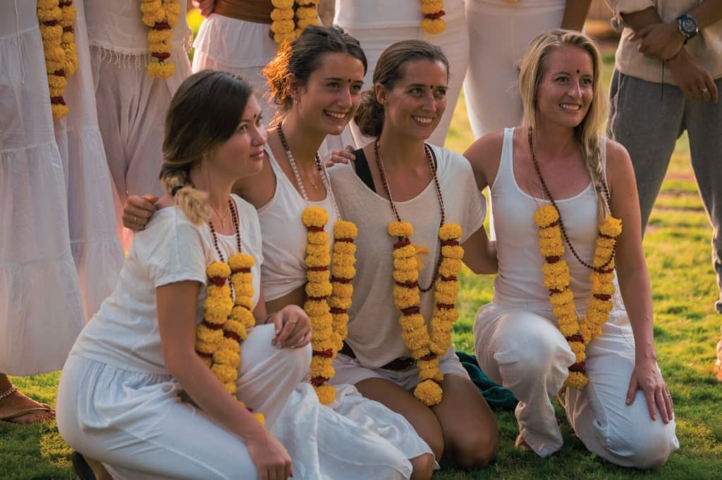 Group of graduates celebrating with flower garlands at Bali Yoga Teacher Training